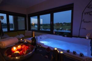 a large bath tub with a bowl of fruit and candles at Beverly Weekend in Butgenbach