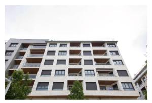 a tall white apartment building with many windows at White Cozy Flat in Donostia in Donostia-San Sebastián