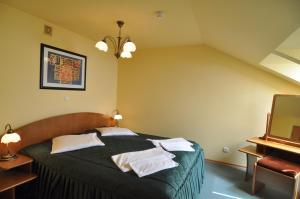 Postel nebo postele na pokoji v ubytování Uzdrowisko Wysowa nad Parkiem