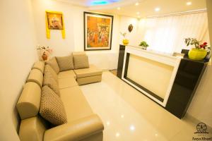 a living room with a couch and a fireplace at Aarya Chaitya Inn in Kathmandu