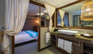 a bathroom with a sink and a bed at C Mauritius in Belle Mare