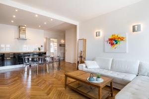 a living room with a white couch and a table at Saxe And The City , Downtown Lyon in Lyon