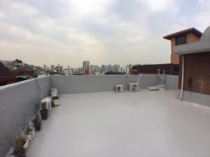 a balcony with a view of a city at Kang's Apartments in Central Seoul in Seoul