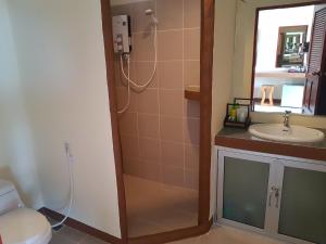 a bathroom with a shower and a toilet and a sink at Moonstone Studio in Haad Rin