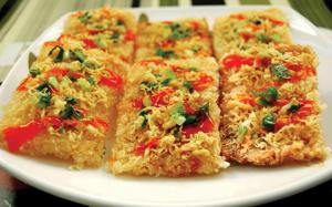 four slices of pizza on a white plate at Van Giang Hotel in Ninh Binh