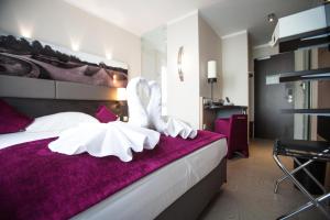 Postel nebo postele na pokoji v ubytování Amalienburg - Boutique & Boarding Hotel + 37 fotografií