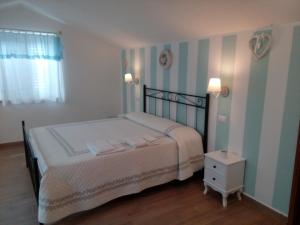 Łóżko lub łóżka w pokoju w obiekcie B&B Le Rose
