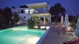 a house with a swimming pool at night at Agriturismo Donna Clementina in Castellaneta Marina
