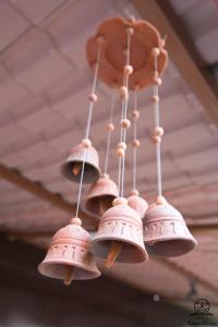 a bunch of bells hanging from a ceiling at Aarya Chaitya Inn in Kathmandu
