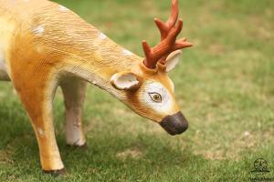a plastic deer head with antlers on the grass at Aarya Chaitya Inn in Kathmandu