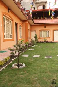 a house with a small tree in the yard at Aarya Chaitya Inn in Kathmandu