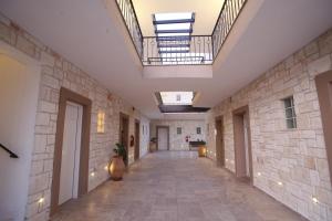 an empty hallway of a building with skylights at Nostos Hotel in Afitos