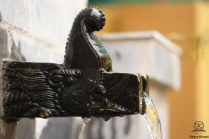 a black bird fountain with water coming out of it at Aarya Chaitya Inn in Kathmandu