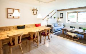 a living room with a large wooden table and chairs at Haus Sonneneck in Fügen