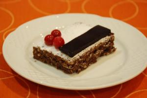 a piece of cake on a white plate on a table at Hostal Delgado in Benabarre