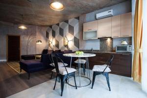 a kitchen and living room with a table and chairs at Apartment near the sea in Gribovka
