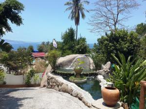 a garden with a pond in the middle of a yard at Moonstone Studio in Haad Rin