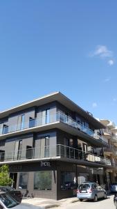 a large building with cars parked in front of it at Argolis Hotel in Nafplio