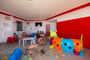 a group of children playing in a room with toys at Tus'Hotel in Castel di Tusa