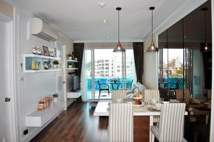 a dining room and living room with a table and chairs at My resort Huahin by D511 in Hua Hin