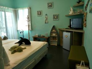 a bedroom with a bed with a stuffed animal on it at Summer House Hualien Homestay in Yuli +14 photos