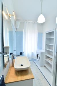 a bathroom with a sink and a washing machine at Villa Elisabetta Apartments in Pula +25 photos