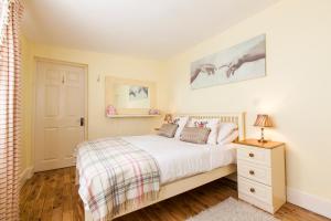 a bedroom with a white bed and a night stand at Dublin Vacation Rentals in Dublin