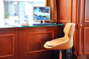 a computer sitting on top of a desk with a chair at Hotel Centrum Istanbul in Istanbul