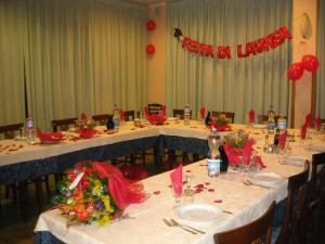 a group of tables in a room with red decorations at Hotel Ristorante Giardino in Abbadia San Salvatore