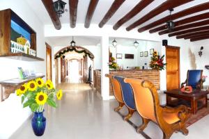a living room filled with furniture and a table at Hotel Boutique Villa Roma in Villa de Leyva
