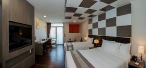 A bed or beds in a room at Hotel Parami