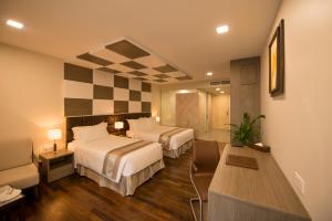 A bed or beds in a room at Hotel Parami