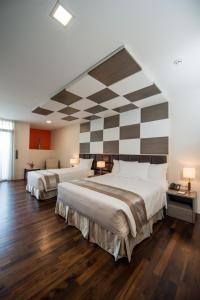A bed or beds in a room at Hotel Parami