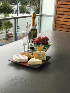 a plate of cheese and grapes and a bottle of wine at No 3 @ The Quay in Picton