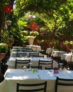 a row of tables with white tablecloths and chairs at Antica Locanda Montin in Venice
