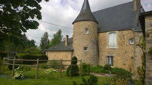 an old stone house with a turret at Manoir de la Grand'Cour in Soulgé-sur-ouette