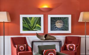 a room with two chairs and two pictures on the wall at Hotel Della Piccola Marina in Capri