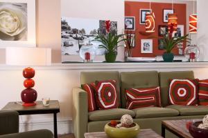 a living room with a couch and pillows at Hotel Della Piccola Marina in Capri