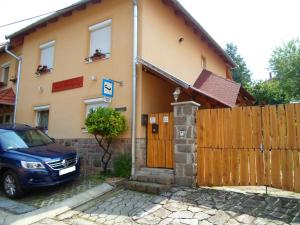 a house with a car parked in front of it at István Vendégház in Eger