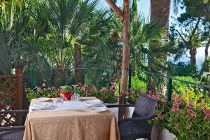 a table with plates and napkins on a patio at Hotel Della Piccola Marina in Capri