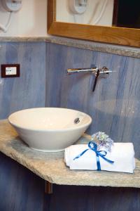 a sink and towels on a counter in a bathroom at Boutique Hotel Elvezia in Stresa