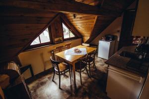 a kitchen with a table and chairs in a cabin at Pension Klondajk in Harrachov