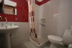 a bathroom with a toilet and a sink and a shower at Chania Rooms in Chania