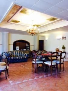 a living room with a couch and a table and chairs at La Lanterna in Avigliano