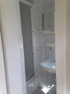 a white bathroom with a sink and a mirror at Ferienwohnung Thiemig in Neuhaus +33 photos