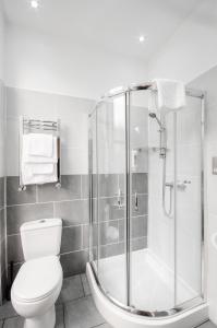 a bathroom with a toilet and a shower at Argyll Apartments in Glasgow +22 photos