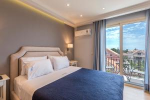 a bedroom with a bed and a large window at Pansion Ermioni in Skala