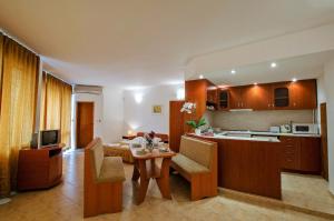 a kitchen and dining room with a table and chairs at Iskar Villas in Kranevo