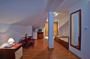 a hotel room with a bed and a desk and a bedroom at Iskar Villas in Kranevo