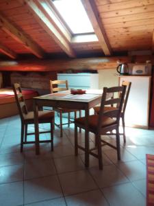 a dining room table and chairs in a kitchen at Casa Di Lena in Gravedona +8 photos